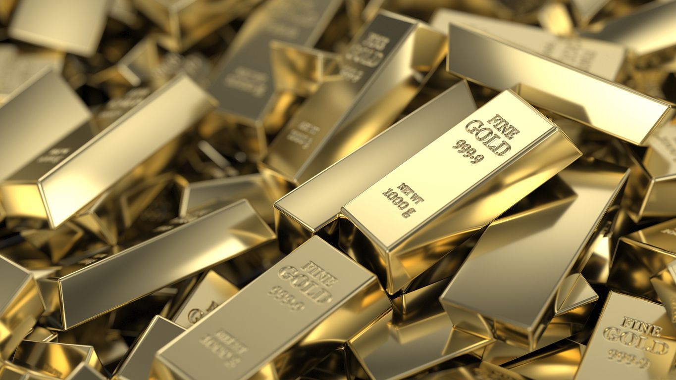 A pile of gold bars stacked on top of each other.