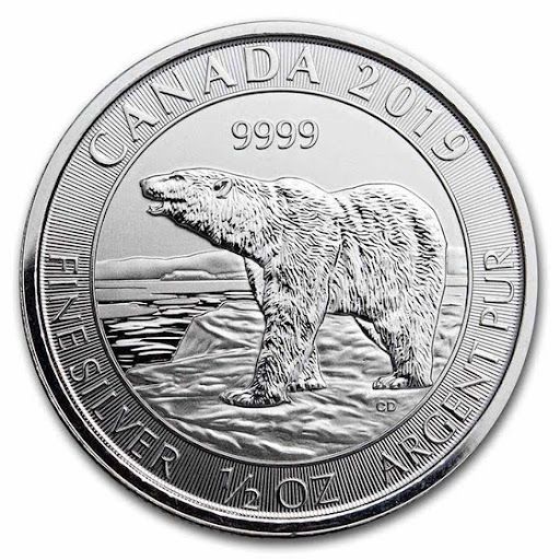 A silver coin with a polar bear on it.