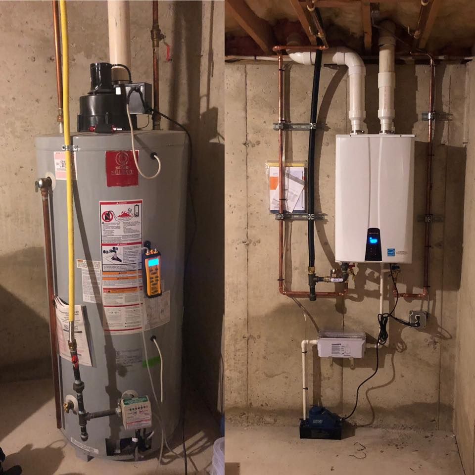 Water heater and tankless heater installed side by side in a basement utility area.