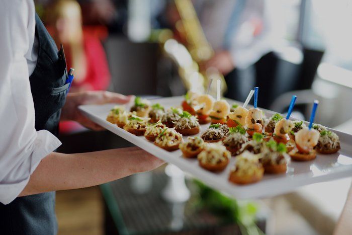 Catering — Waiter Carrying Plates With Meat Dish in Dallas, TX