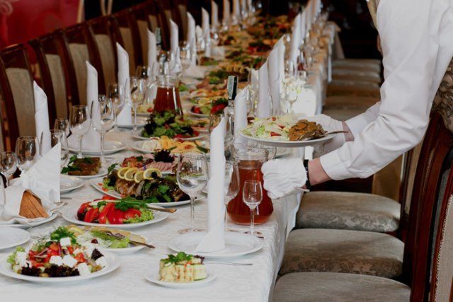 DFW Caterers — Waiter Serving Food at Table in Dallas, TX