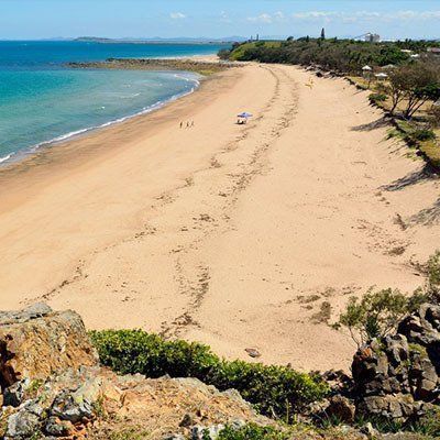 A View Of A Beach From A Cliff Overlooking The Ocean  — River2Coast Concreting in Coffs Harbour, NSW