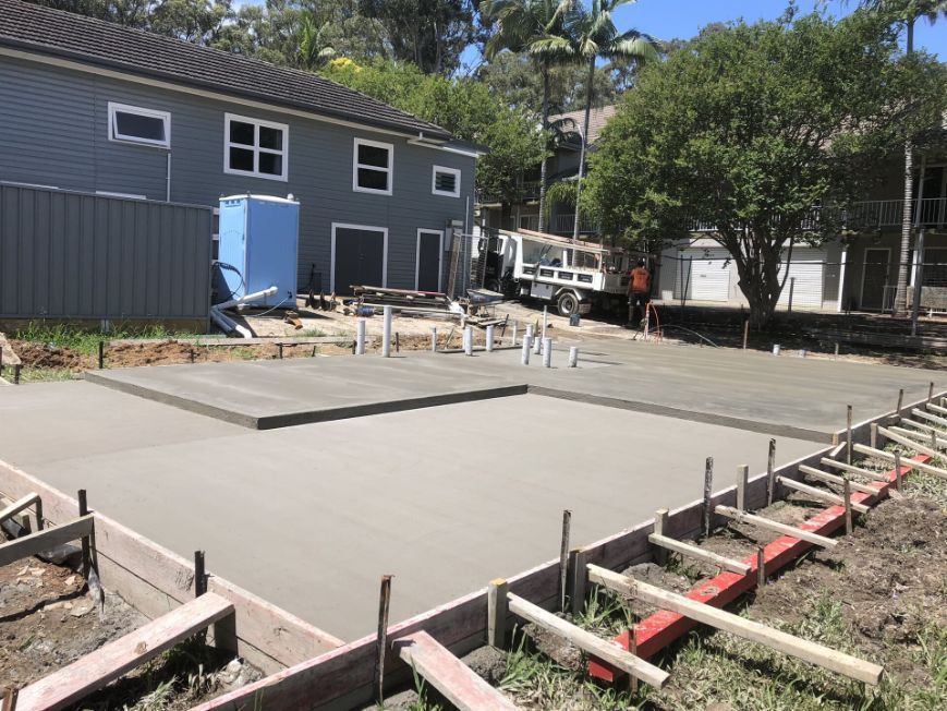 A Concrete Base Is Being Built In Front Of A House — River2Coast Concreting in Boambee, NSW