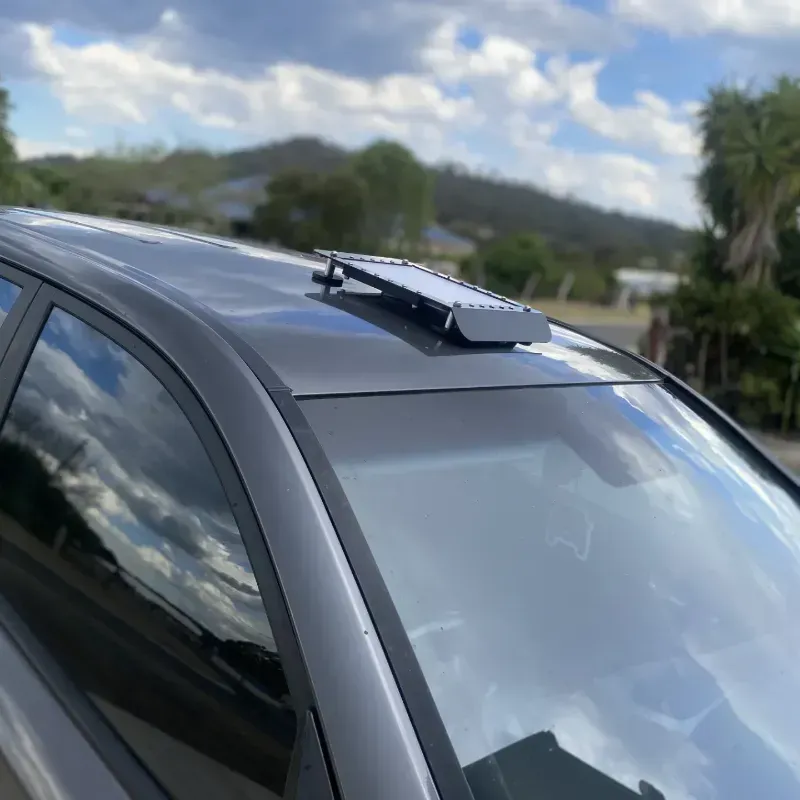 A STARLINK MINI INSTALLED ON THE ROOF OF A CAR