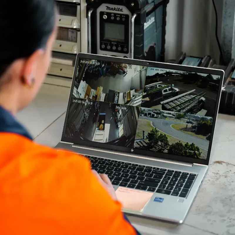 SPLIT-SCREEN SURVEILLANCE OF LIVE SECURITY CAMERA FOOTAGE ON A LAPTAP COMPUTER
