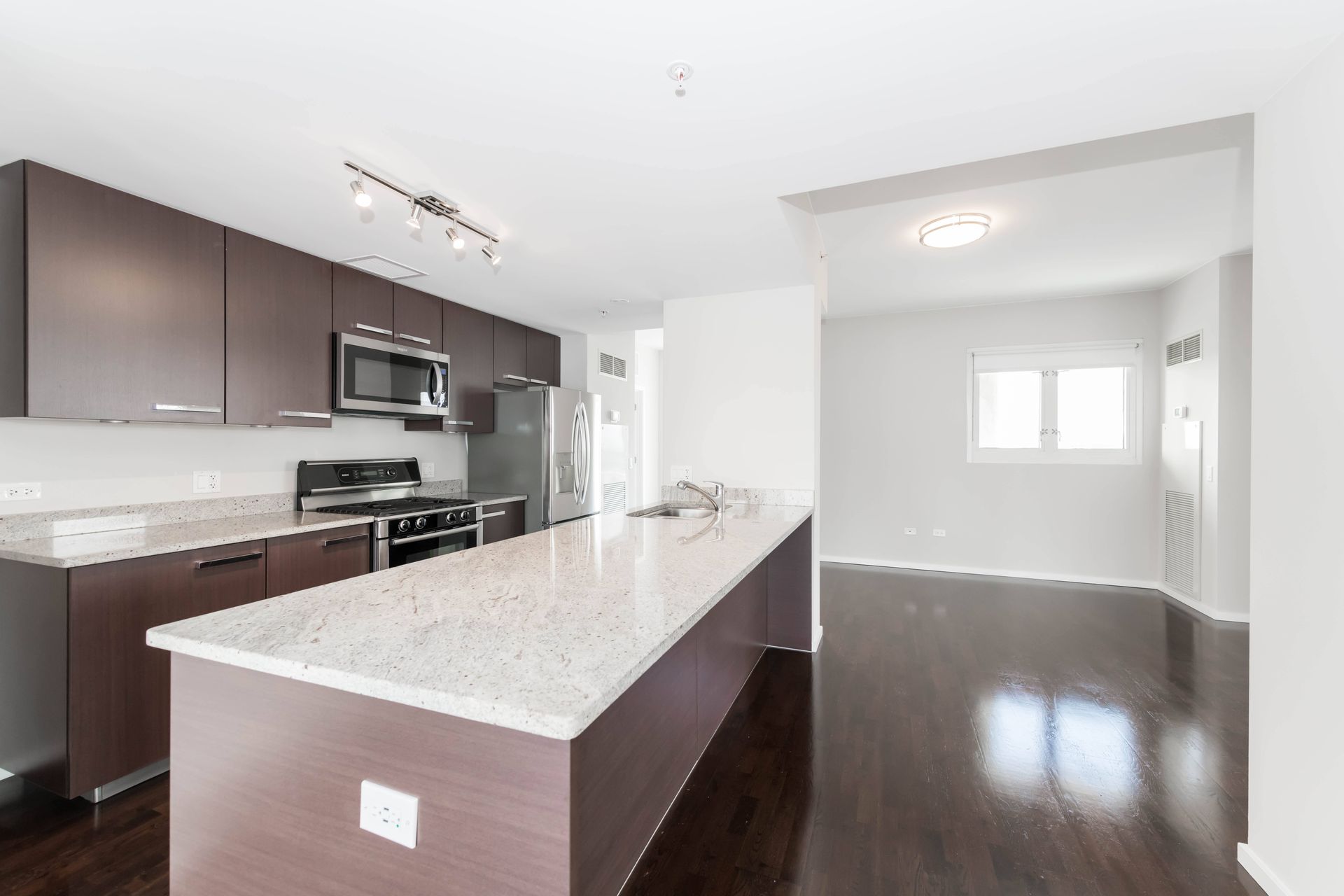 a large kitchen with a marble counter top and