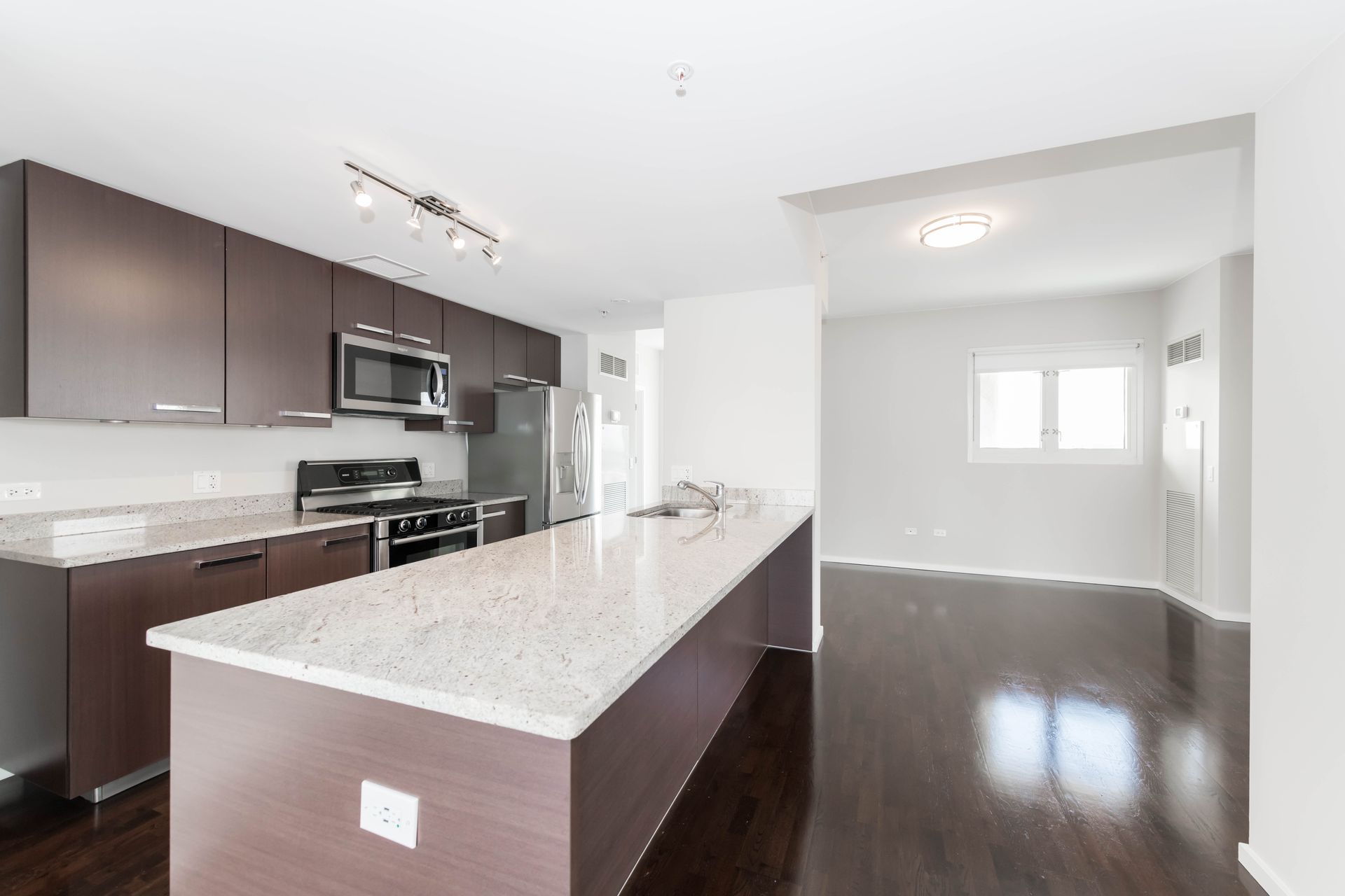 A kitchen with a large island in the middle of it at 24 S Morgan Apartments.