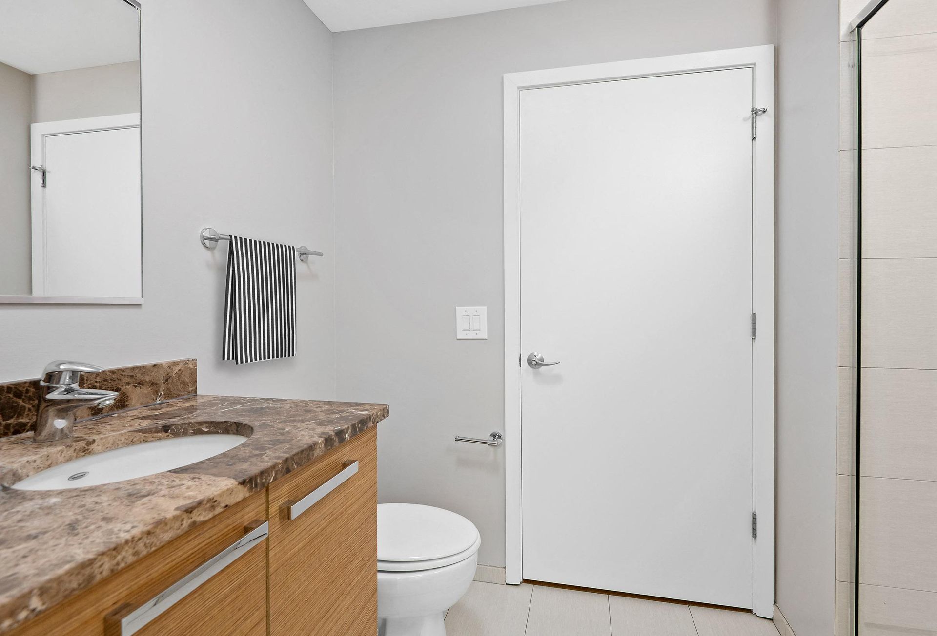 a bathroom with a toilet sink and shower