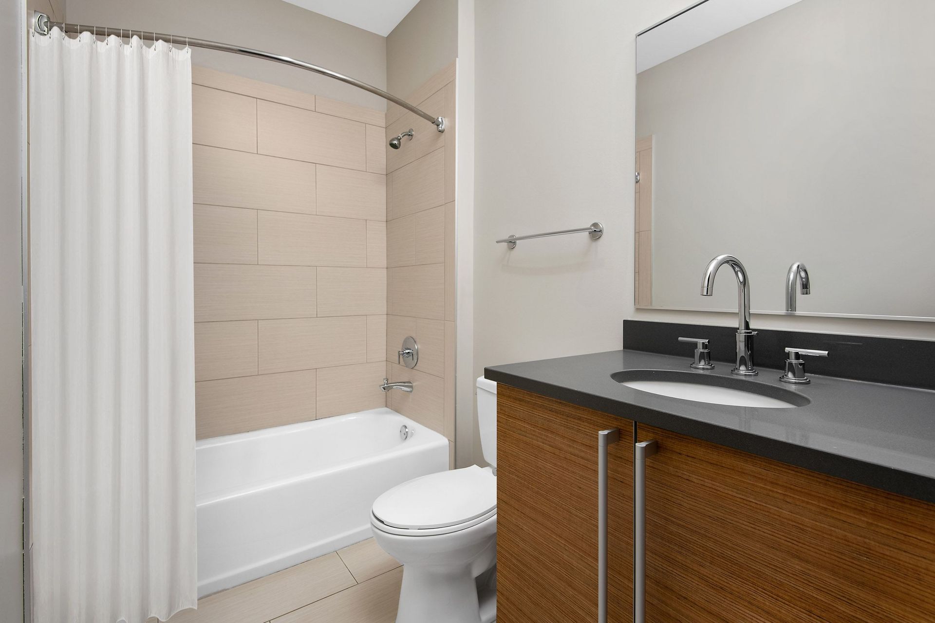 a bathroom with a sink toilet and tub and a shower curtain