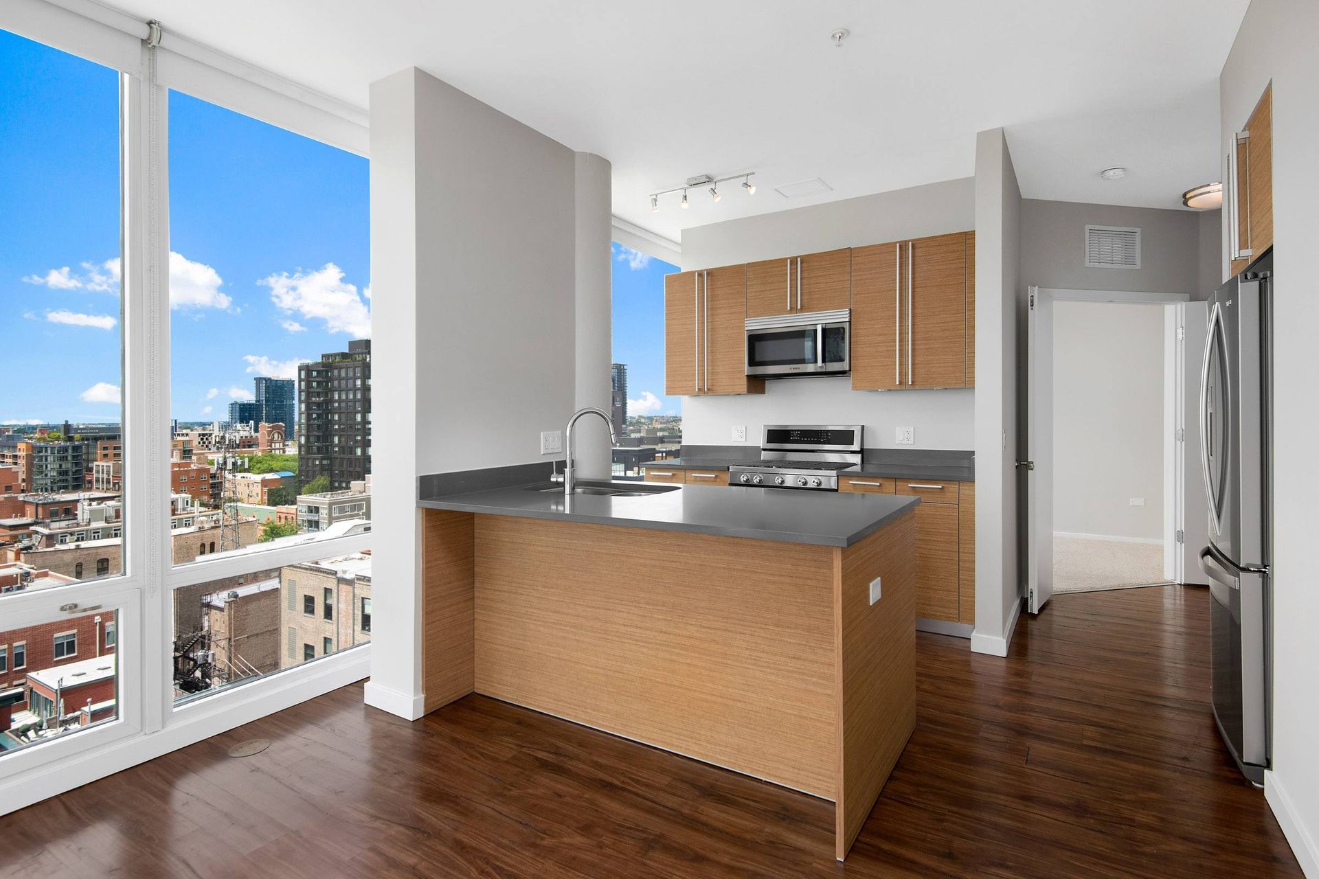 a kitchen with a large window and a city view