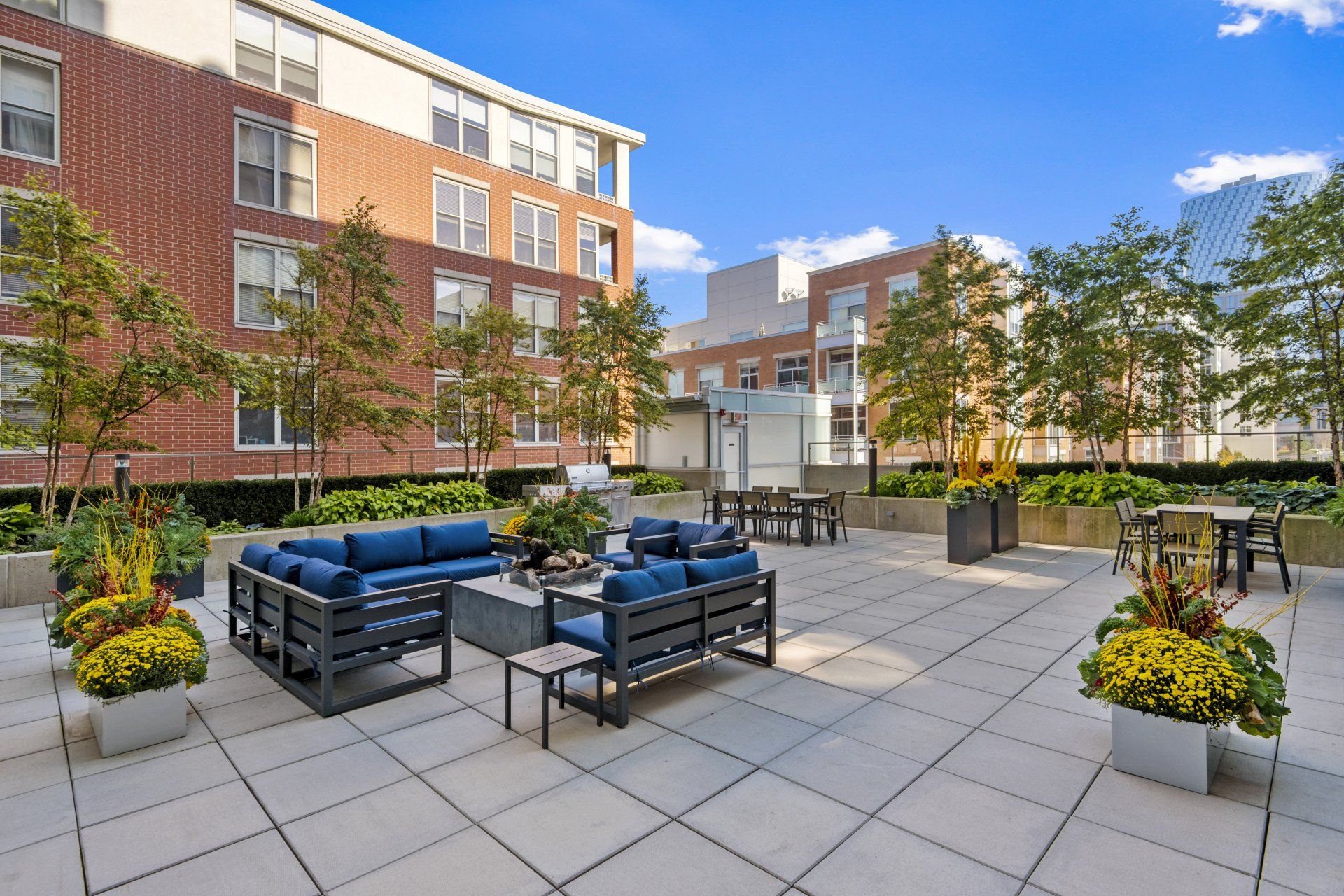 A patio with a lot of furniture in front of a building  at 24 S Morgan Apartments.