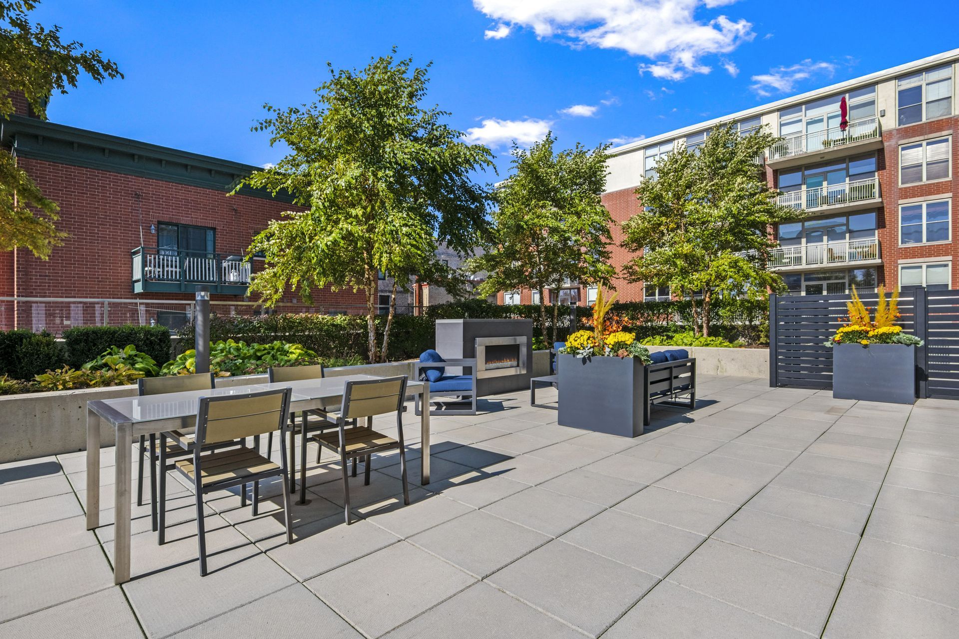 Additional roof deck at 24 S Morgan with tables, chairs and a fire place.