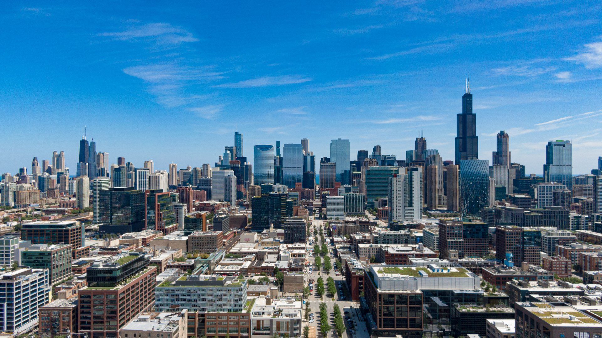 An aerial view of a city skyline on a sunny day.