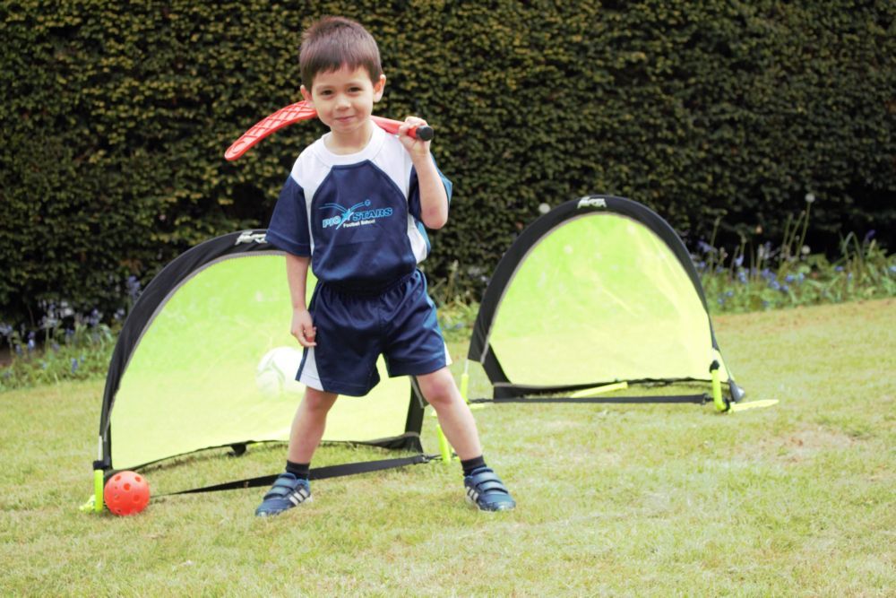 Early Development - posing with hockey stick and ball