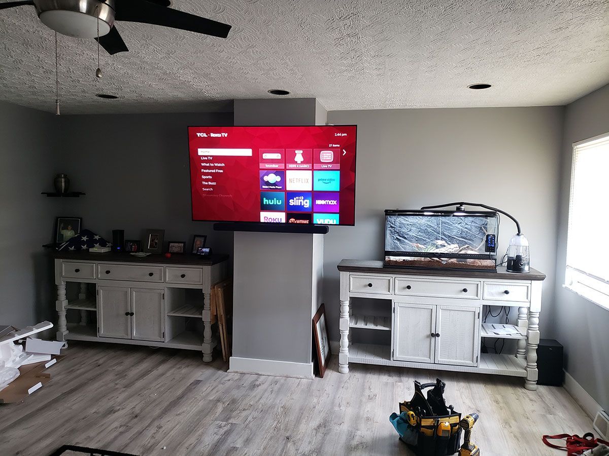 A living room with a flat screen tv mounted to the wall