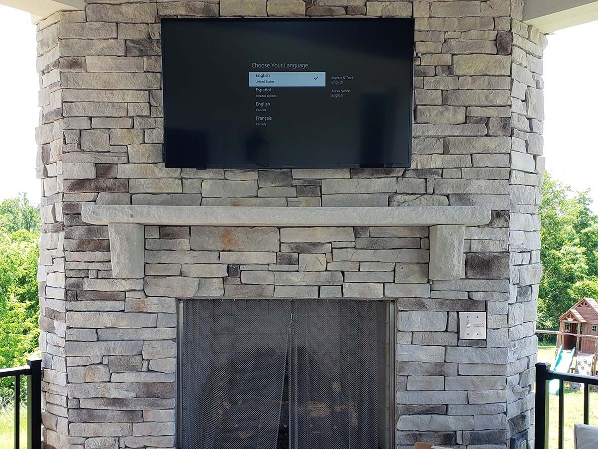 A fireplace with a flat screen tv mounted above it.