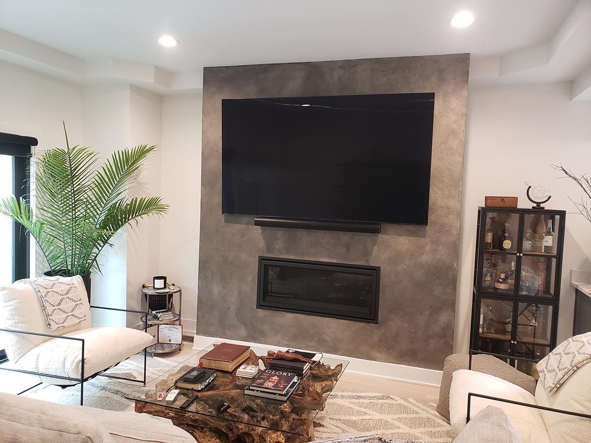 A living room with a large flat screen tv mounted on the wall.