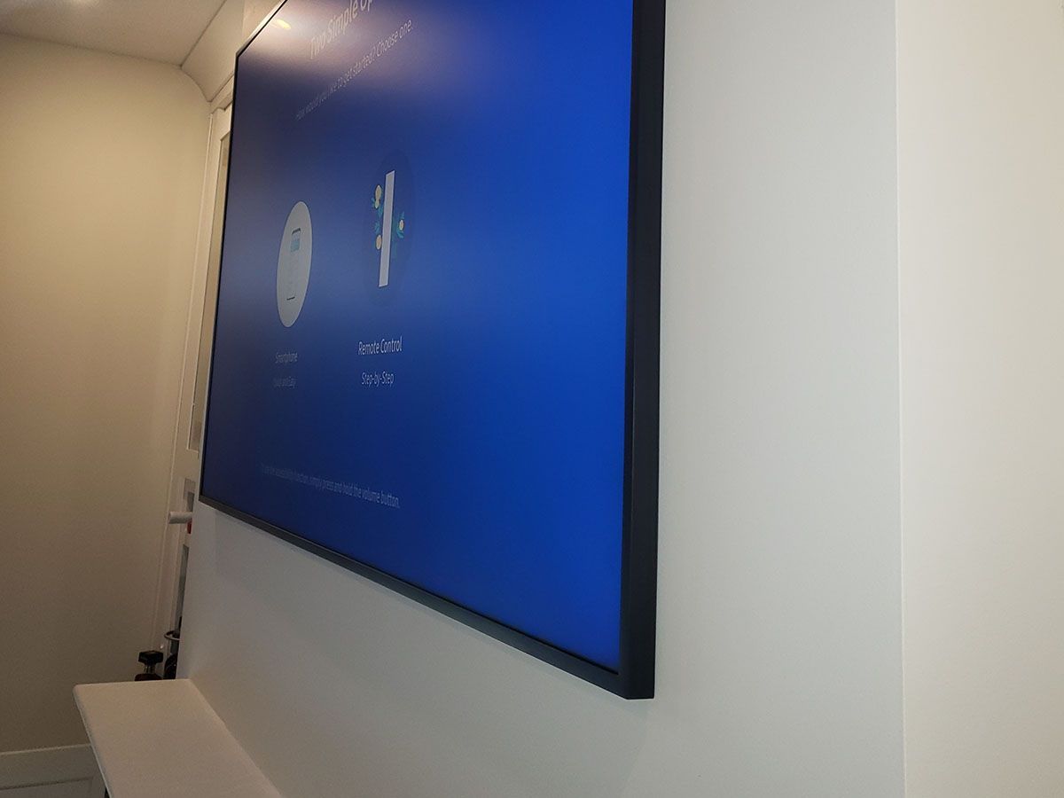A large blue screen is hanging on a white wall