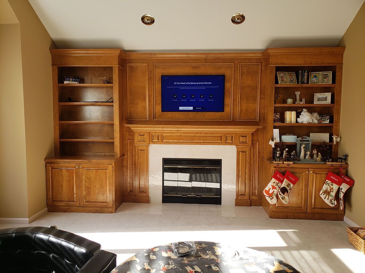A living room with a fireplace and a flat screen tv