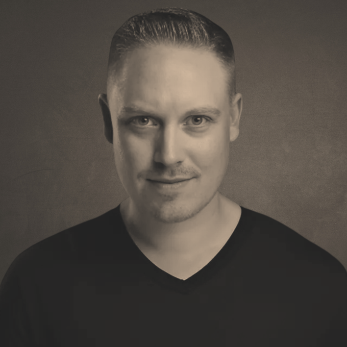 Ken Osborne: A man with a beard is wearing a suit and tie