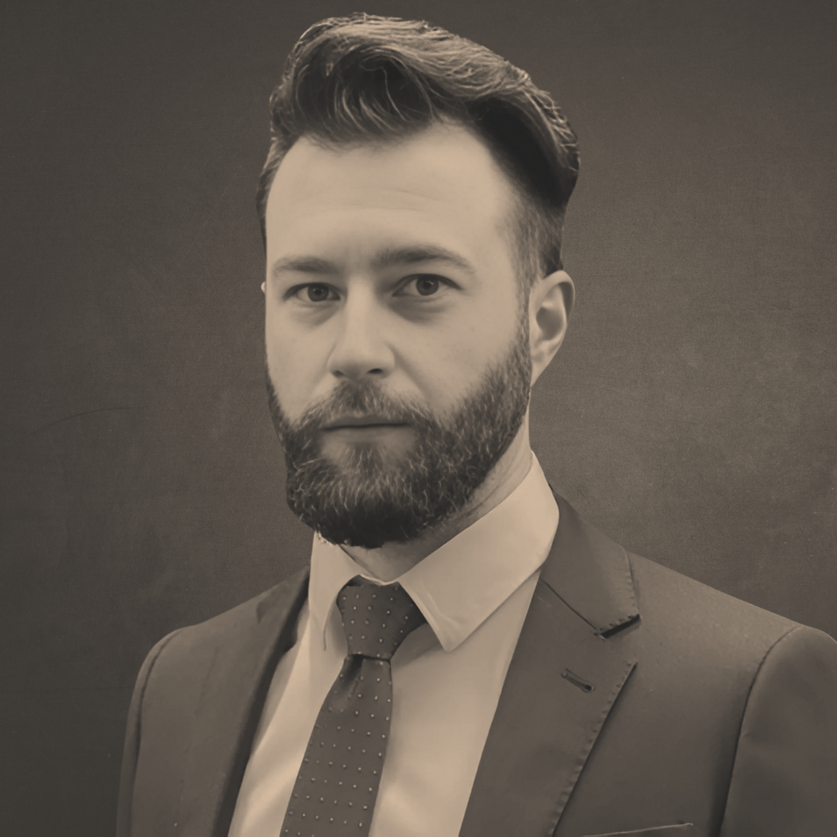 Ken Osborne: A man with a beard is wearing a suit and tie