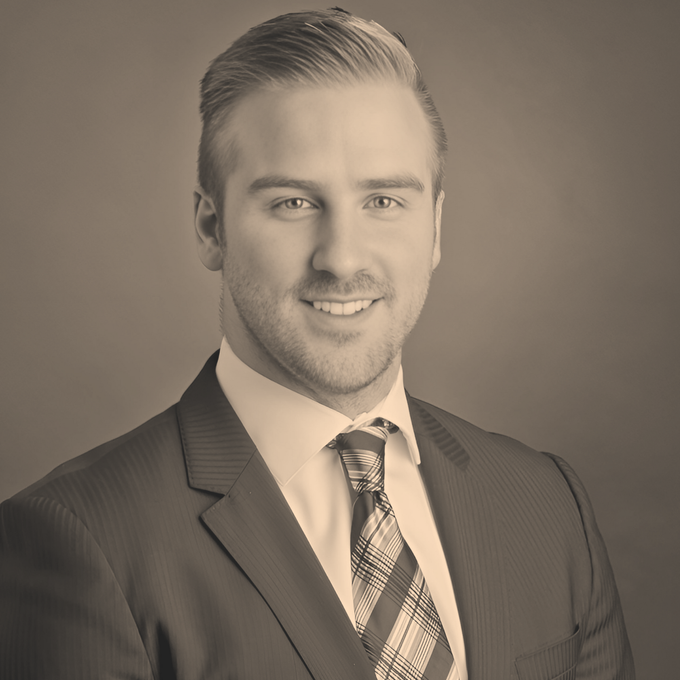 Lachlan McLeod: A man in a suit and tie is smiling for the camera.