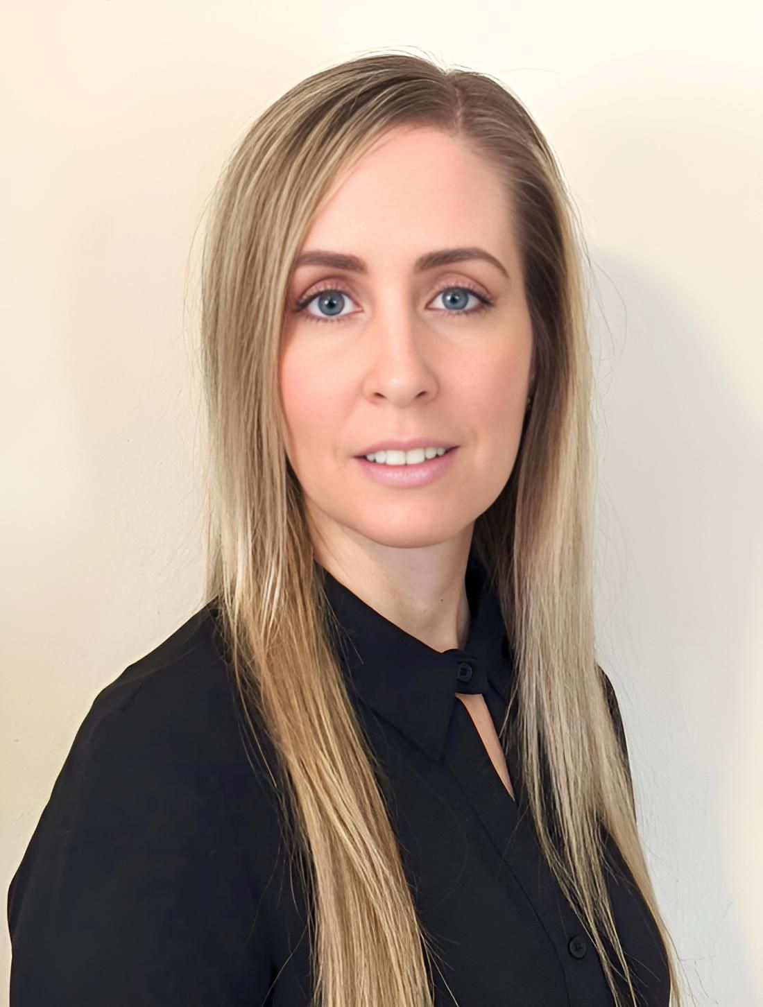 A Woman With Long Blonde Hair Is Wearing A Black Shirt And Smiling For The Camera — HealthPoint Mingara In Tumbi Umbi, NSW