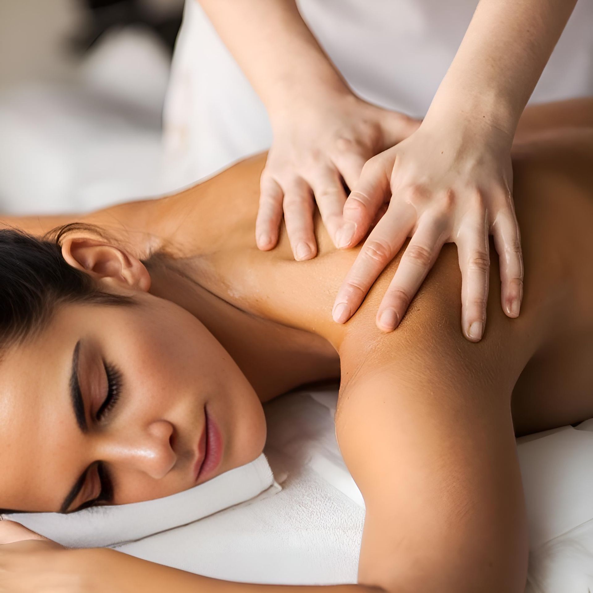 A woman is laying on a bed getting a massage. — HealthPoint Mingara In Tumbi Umbi, NSW