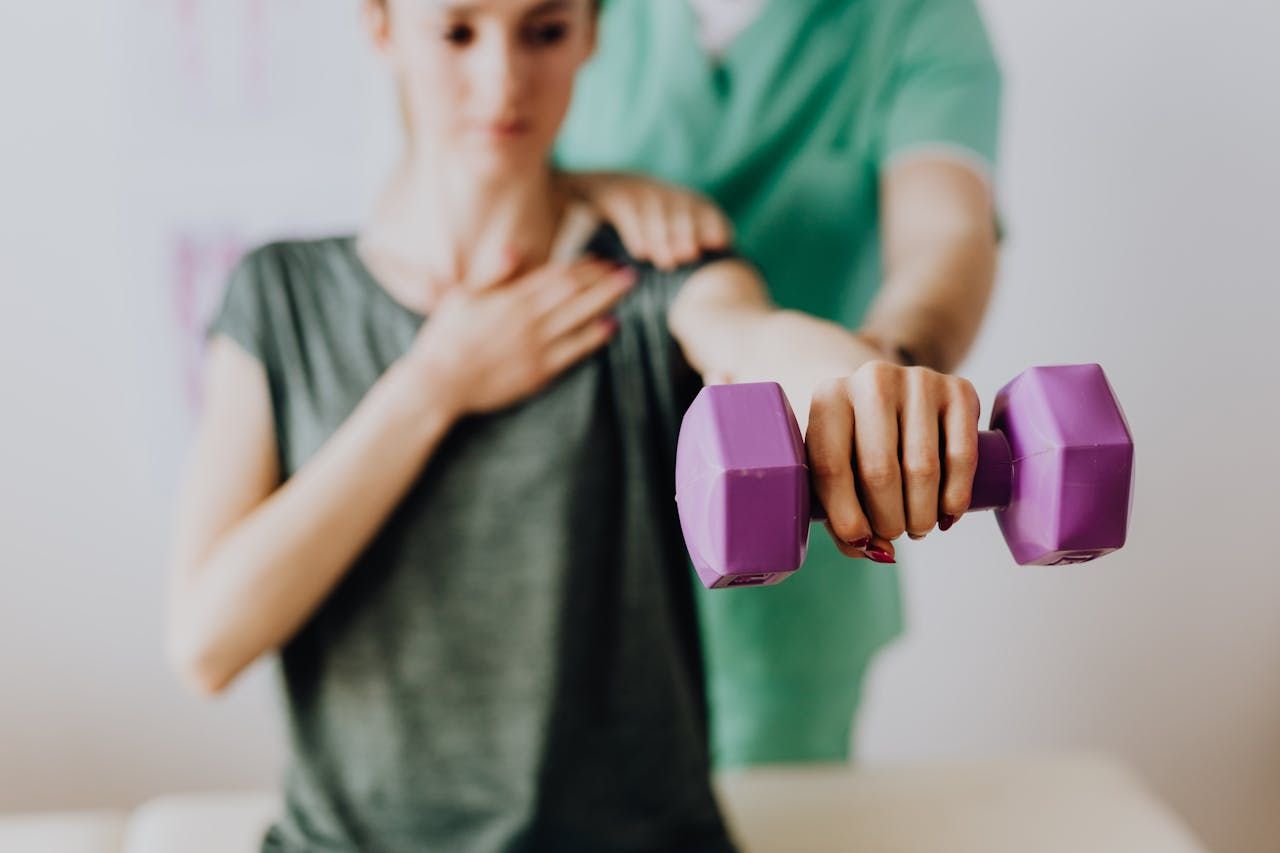 A Woman Holding A Hand Dumbbell — HealthPoint Mingara In Tumbi Umbi, NSW