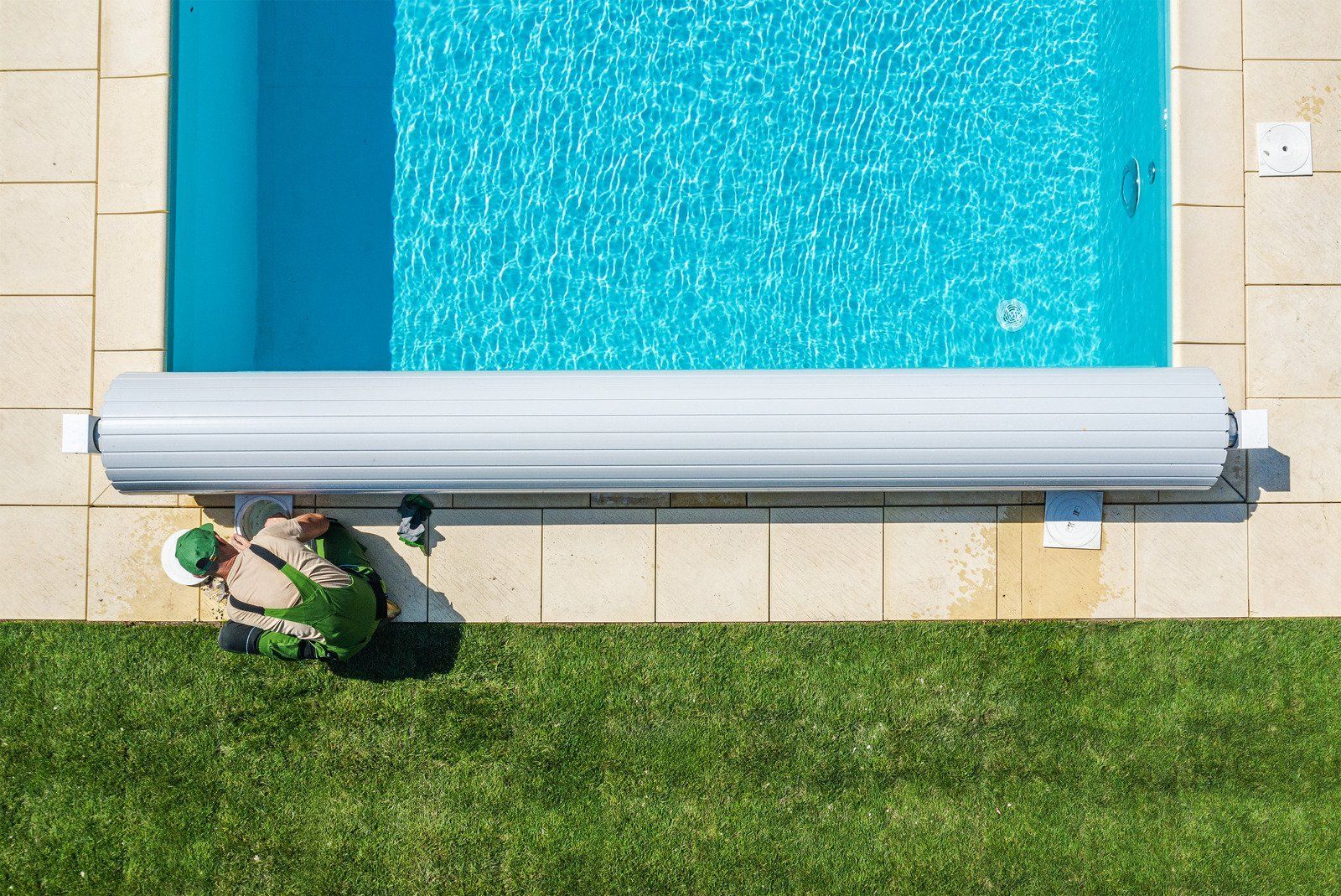 A wooden fence is sitting on top of a lush green field.