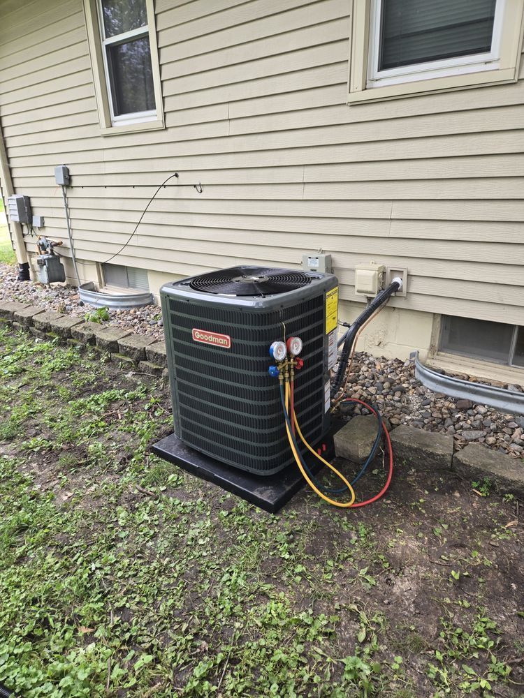 Air conditioning unit outside a house, with gauges connected.