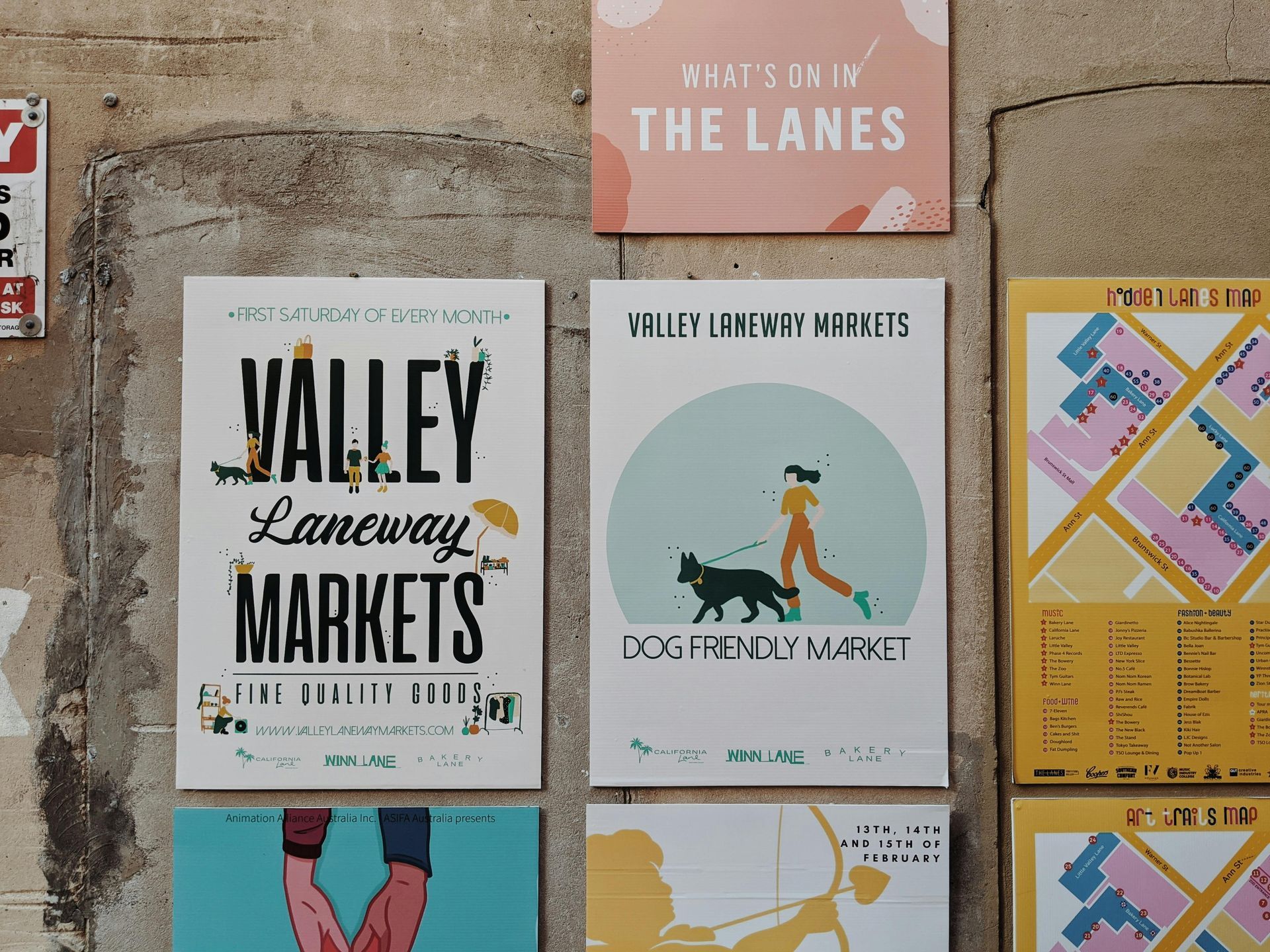 A valley laneway markets sign hangs on a wall
