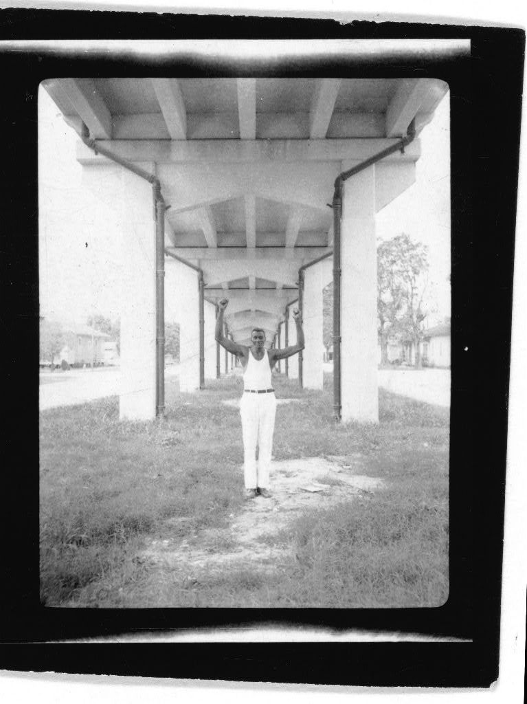 John Bray pretending to hold up a bridge, Amelia, Louisiana. Photo by Alan Lomax, 1934. Prints and Photographs Division.