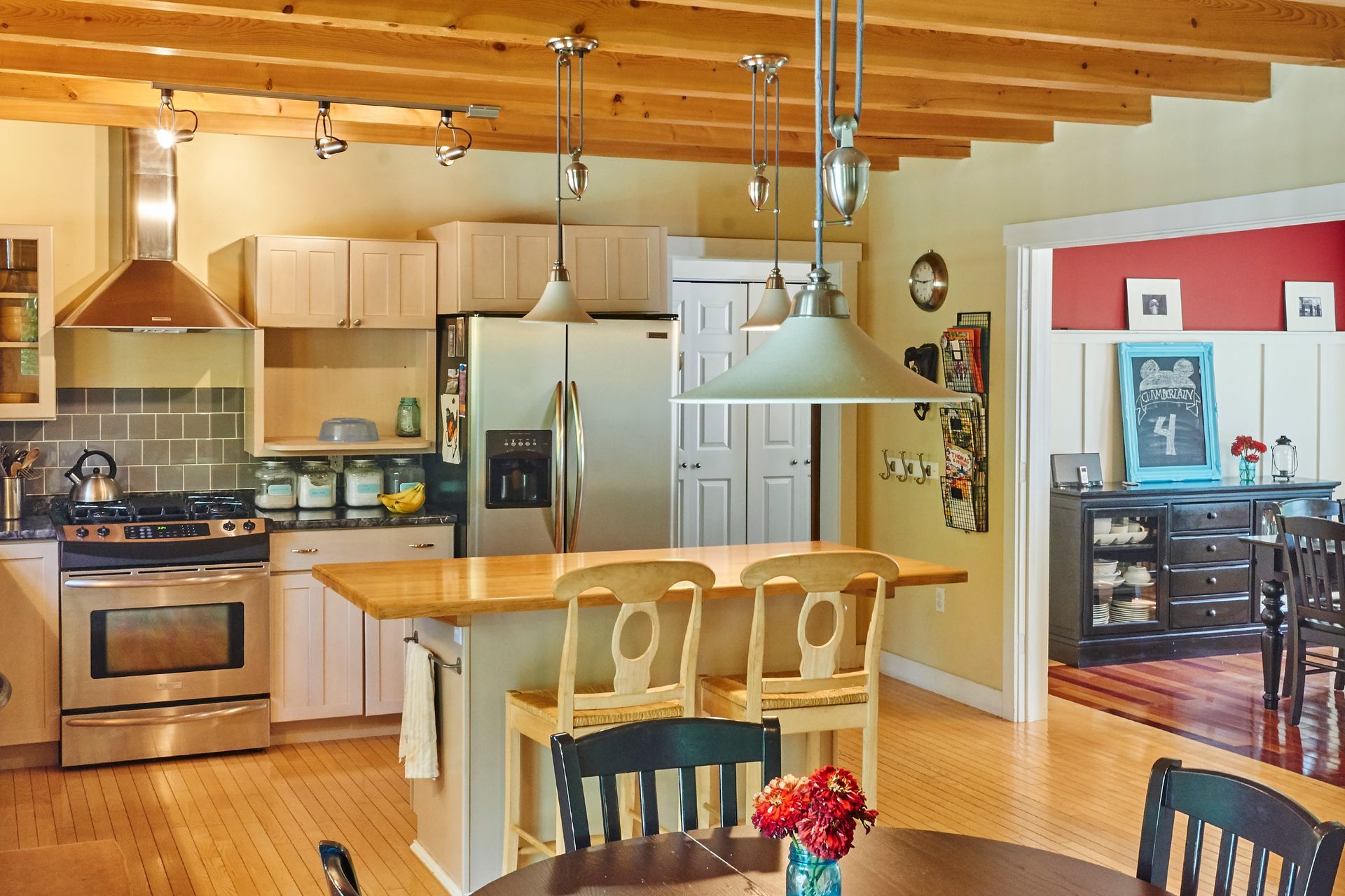 A kitchen with a table and chairs and a refrigerator