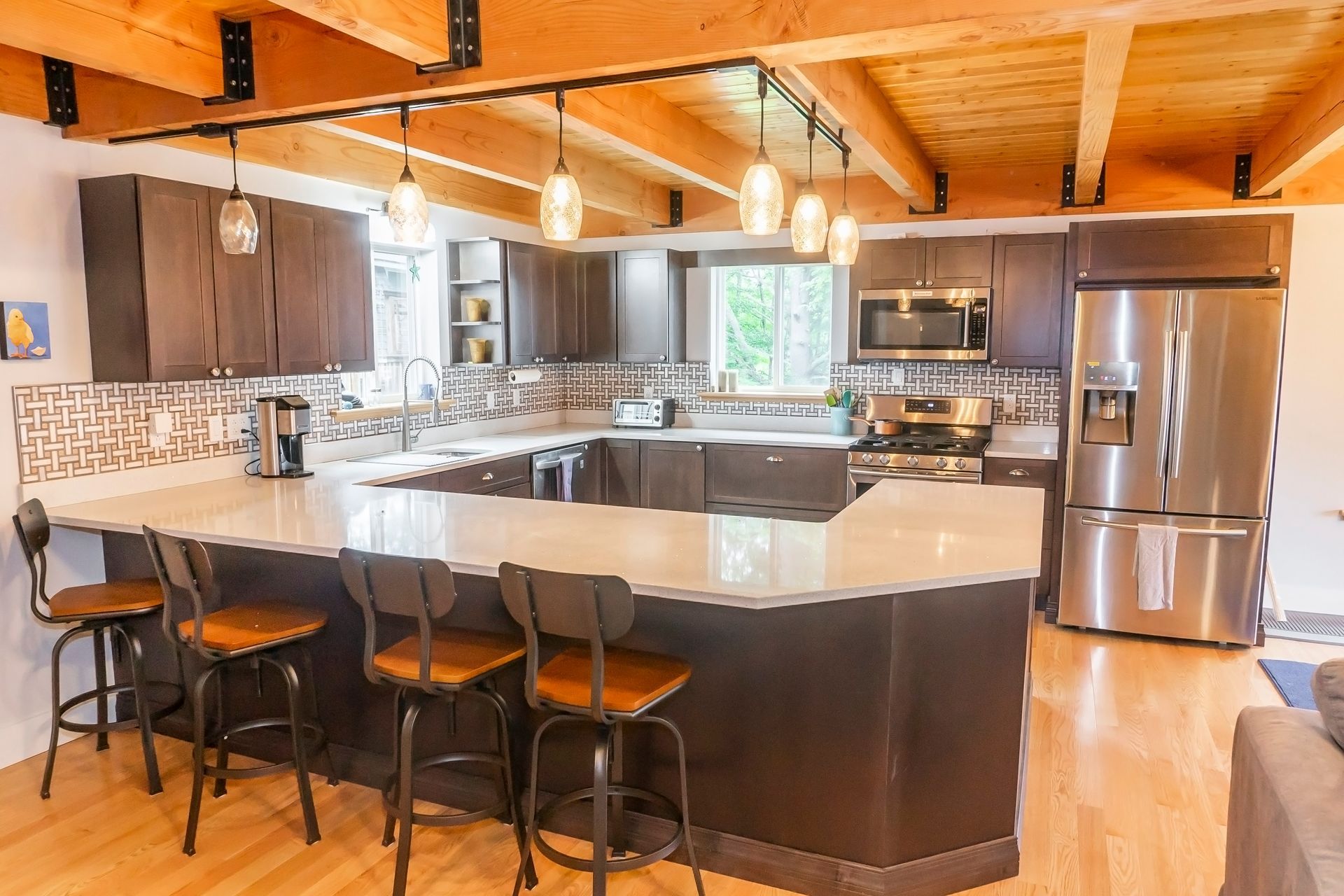A warm-lighted kitchen and cabinetry for a gorgeous looking custom finish carpentry.