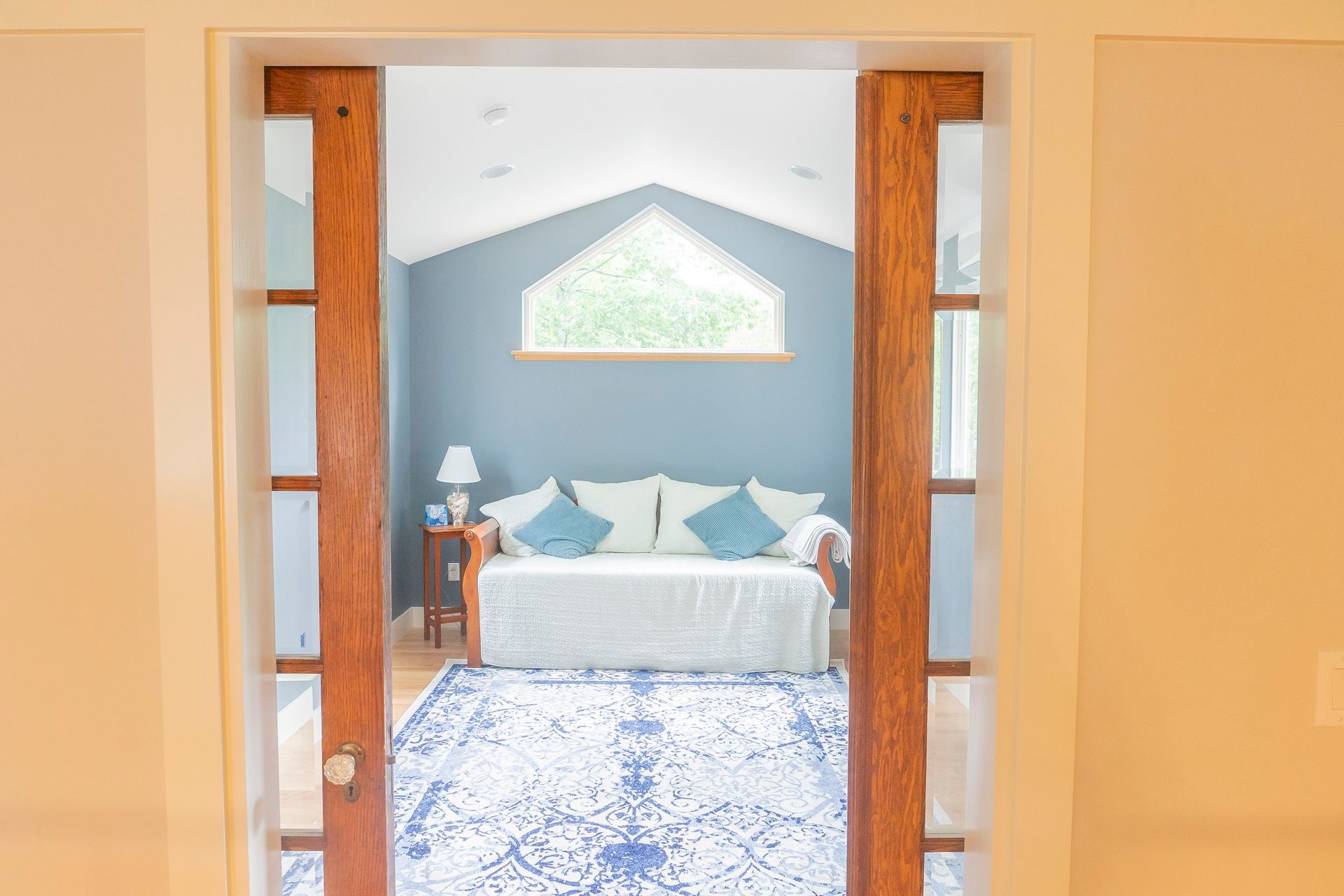 Whitecap Builders refreshed a guest bedroom with new doors, paint, and lighting in Searsmont, Maine.