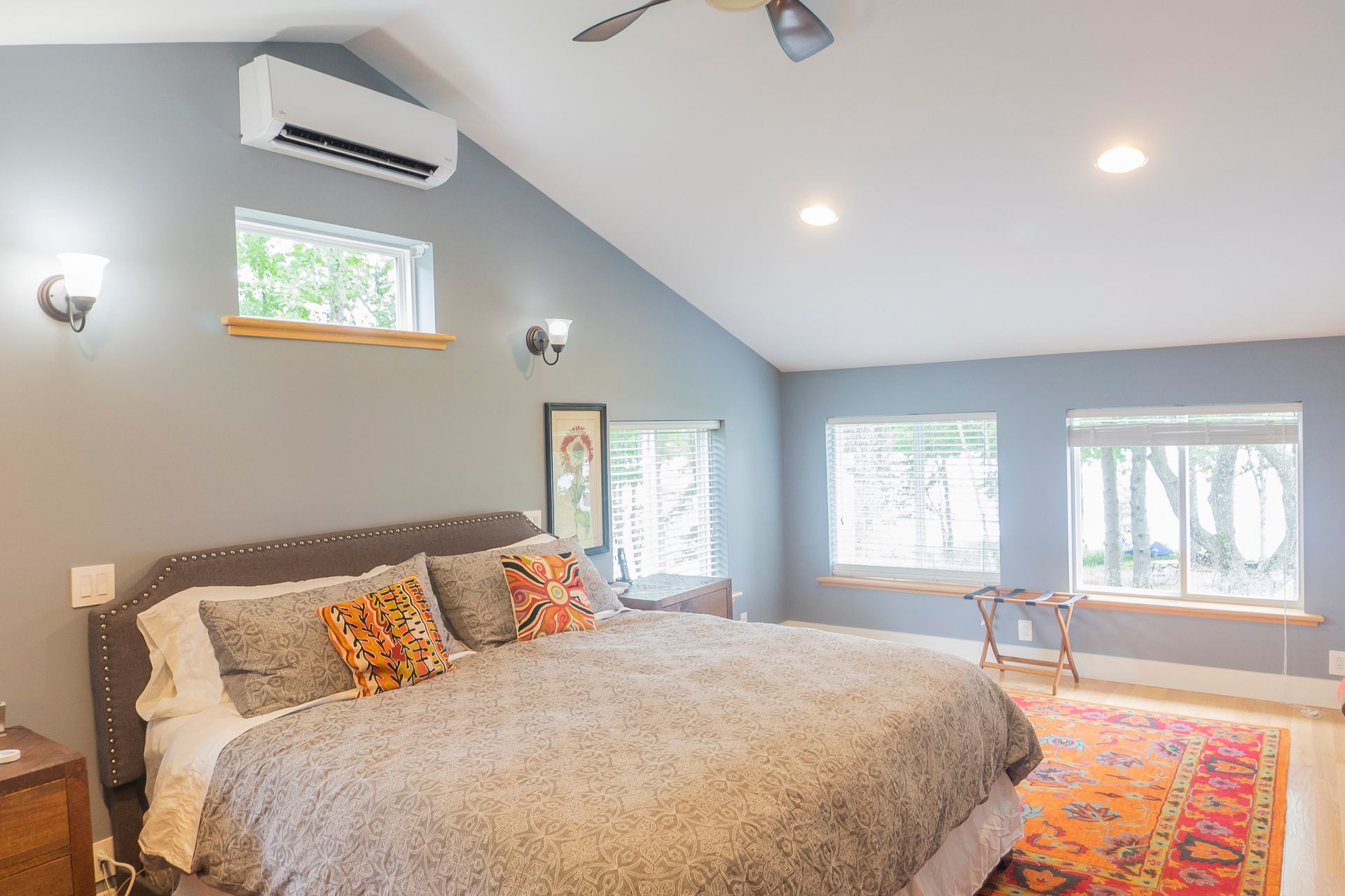 A bedroom with a large bed and a ceiling fan.