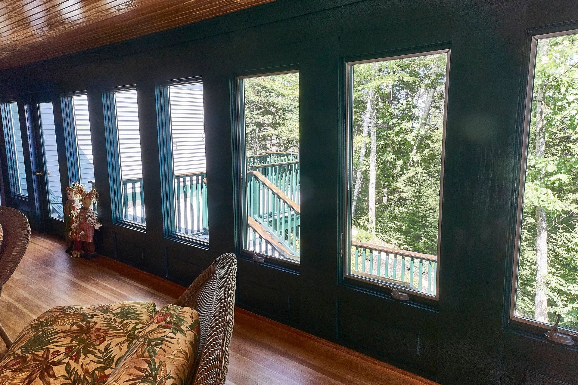 Whitecap Builders built a cedar-lined sunroom with full windows overlooking the woods in Morrill, Maine.