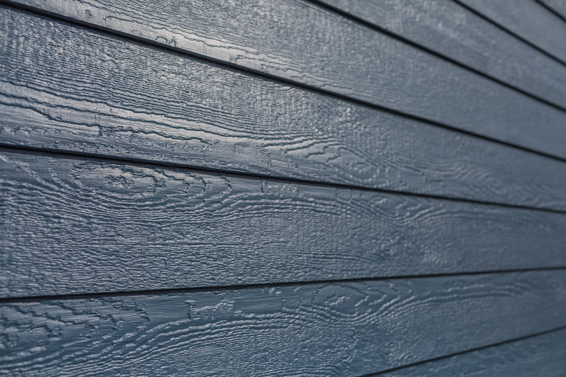A close up of a blue siding on a house