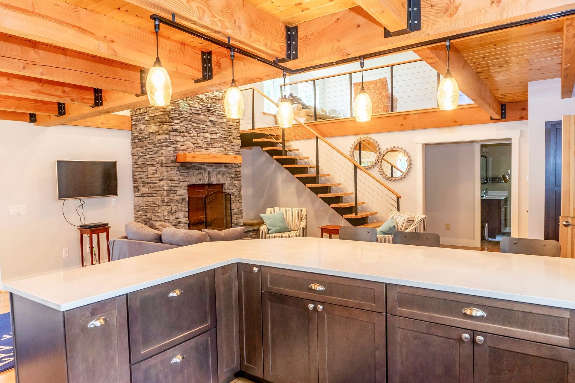 A kitchen with a large island and stairs leading up to the second floor.
