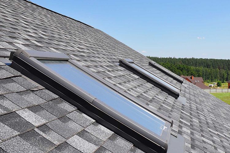 Roof windows and skylights and blue sky
