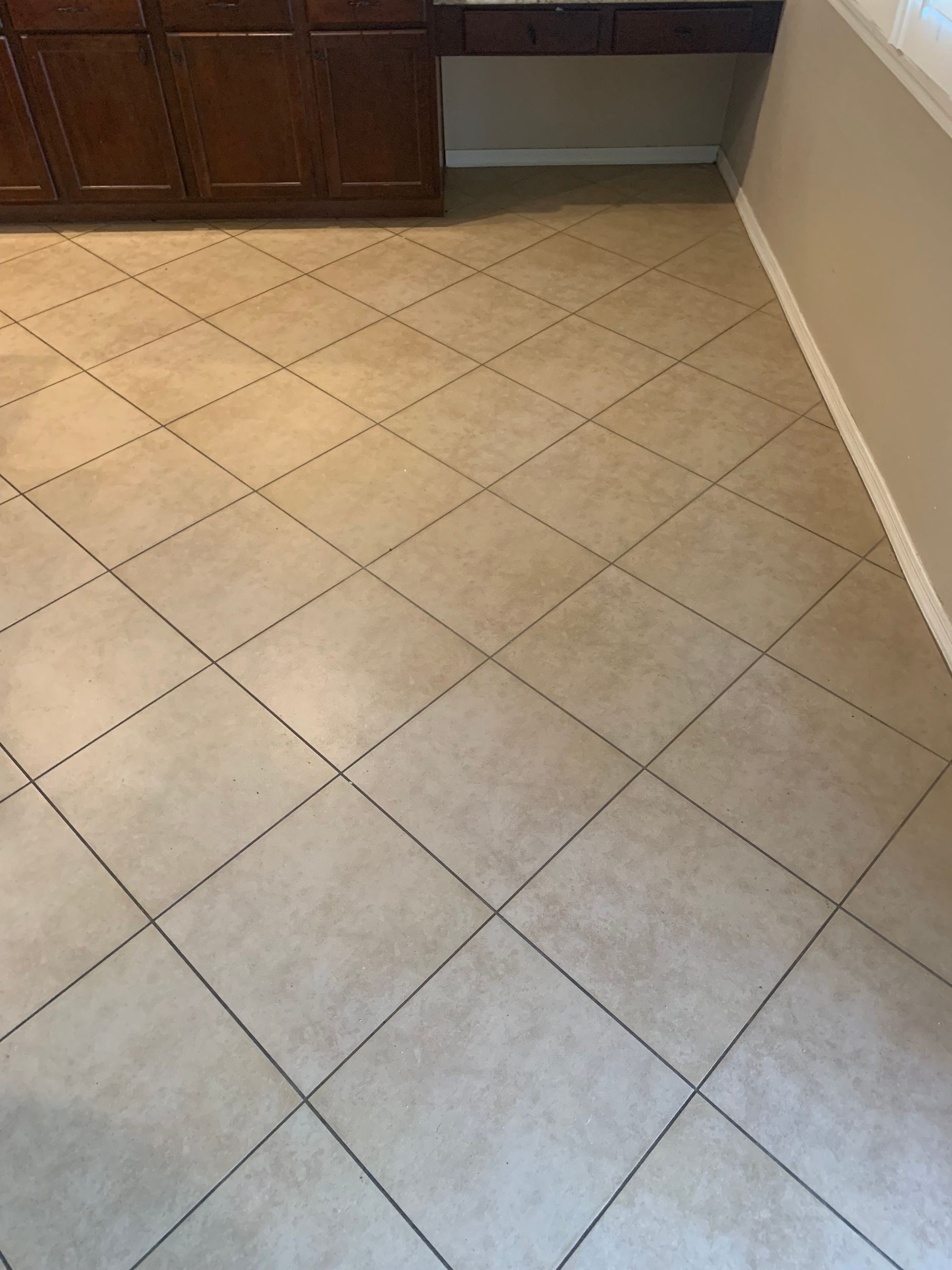 A tiled floor with a diamond pattern in a kitchen