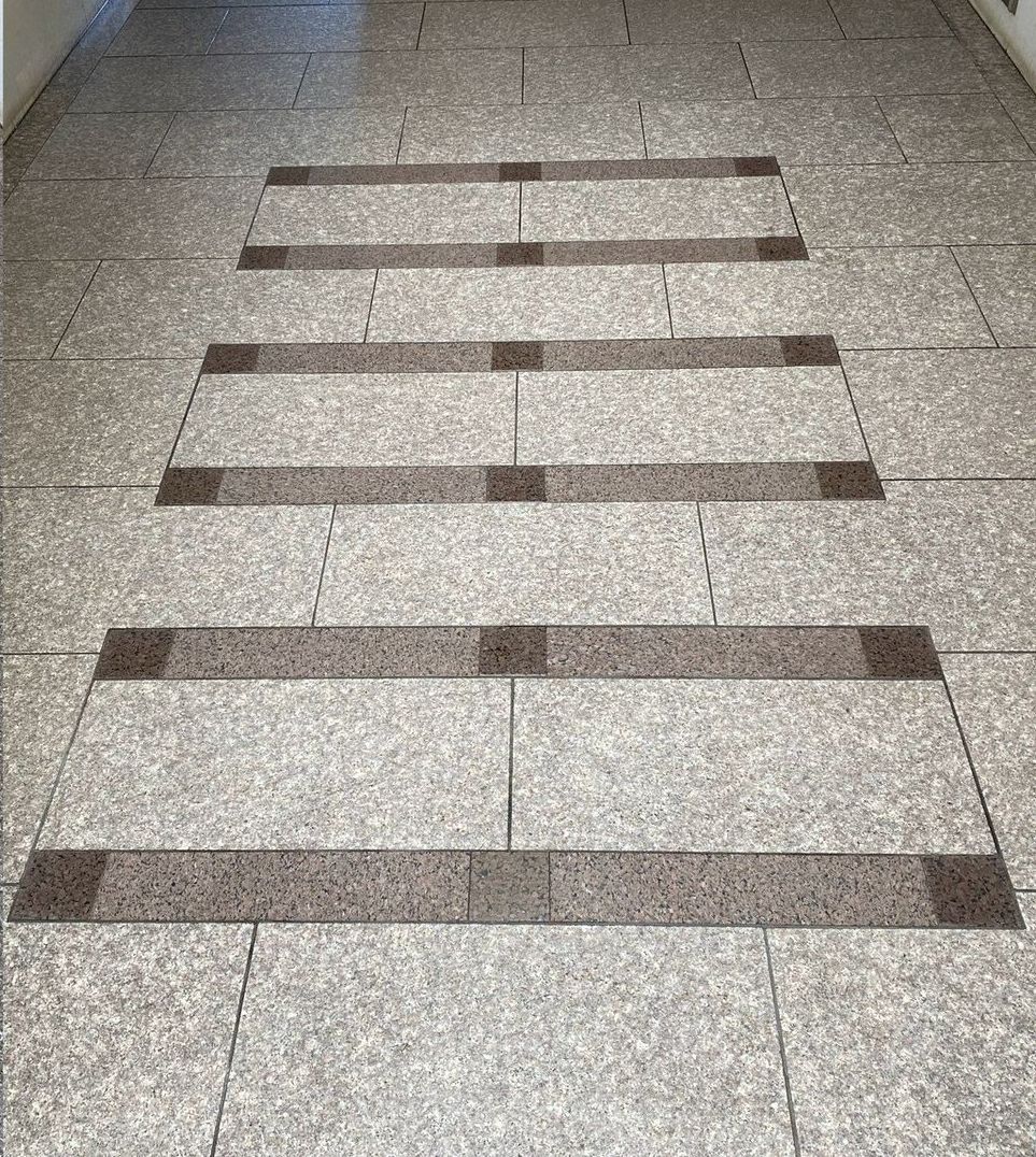 A hallway with a striped pattern on the floor.