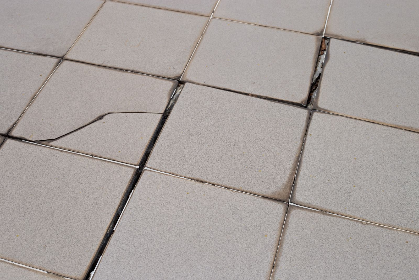 A close up of a cracked tile floor