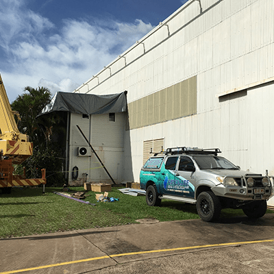 Absolute Plumbing work ute in front of a commercial building - Plumbers in Darwin, NT