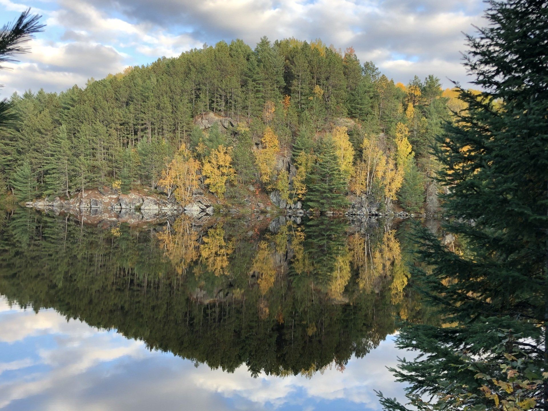 A lake with trees on the shore and a mountain in the background
