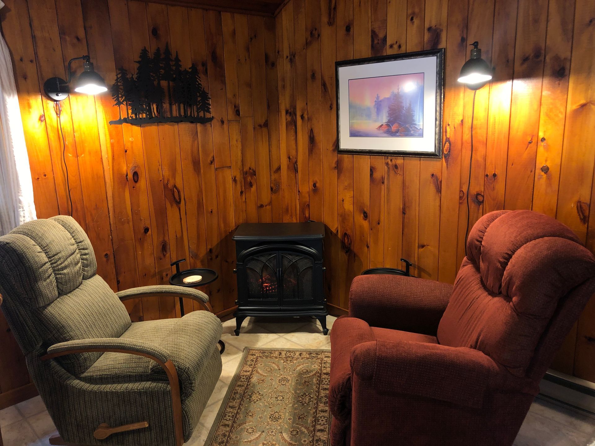 Evergreen cottage living room with two chairs and a fireplace