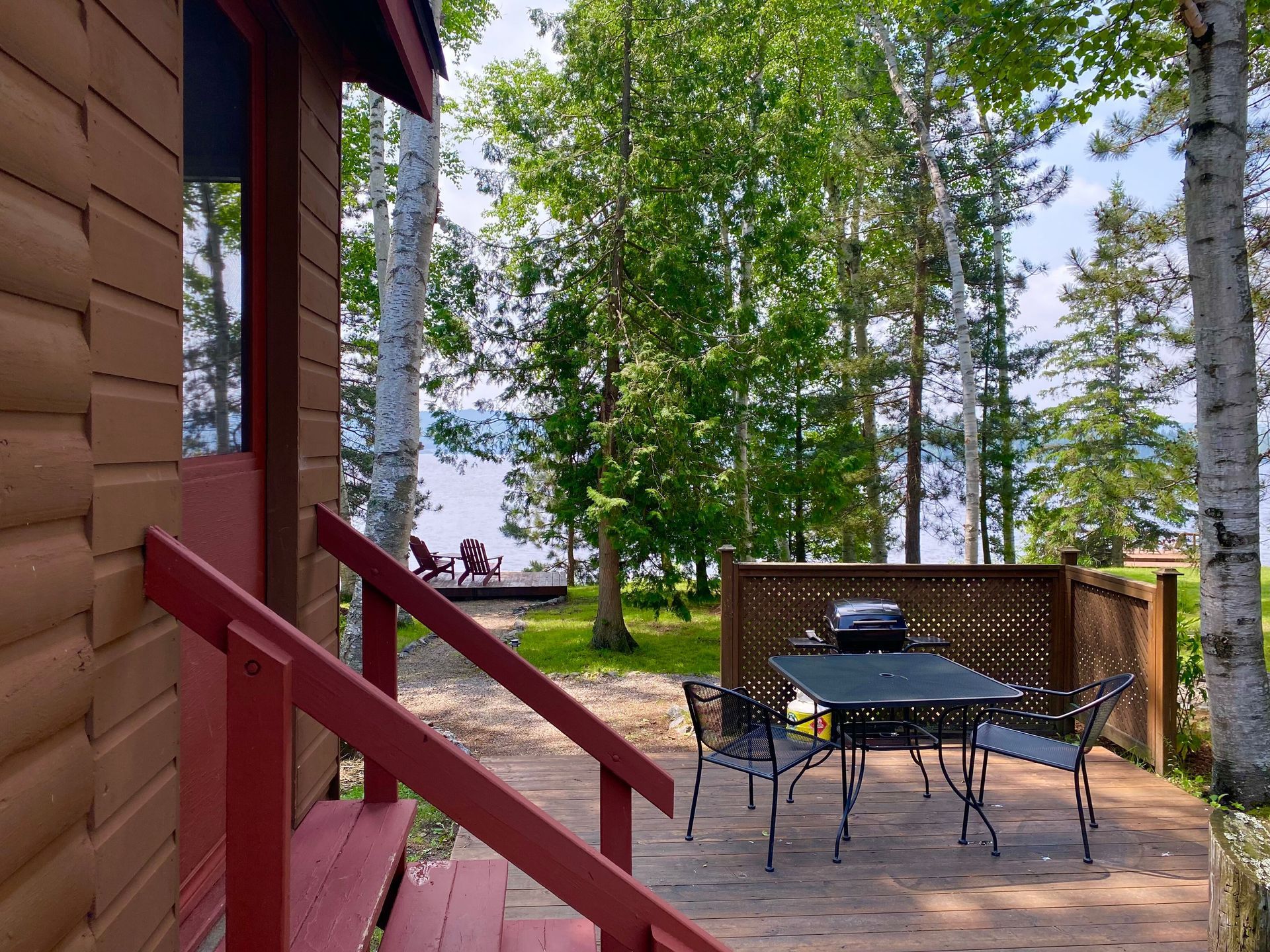 Evergreen cottage exterior table and chairs on the deck.