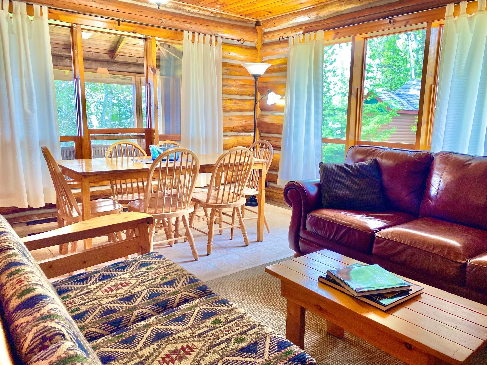 The living room in White Pine cottage with a couch, table and chairs.