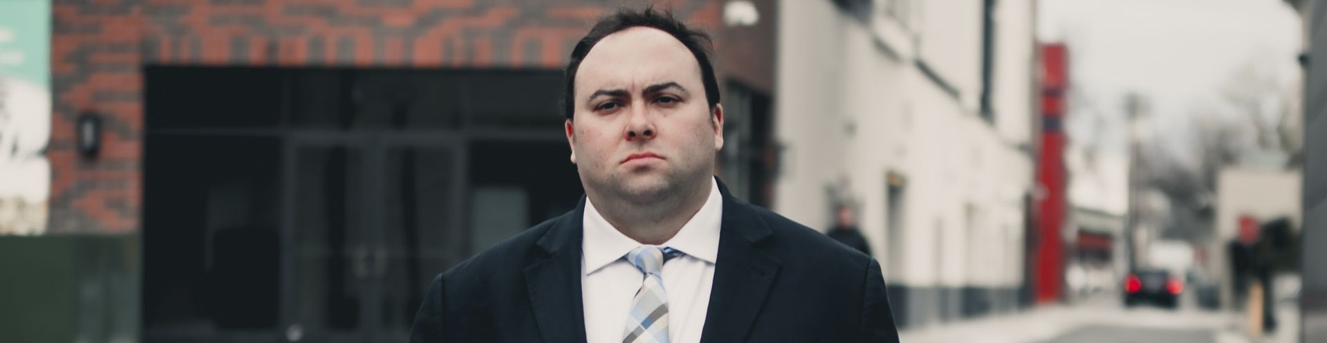 A man in a suit and tie is carrying a briefcase